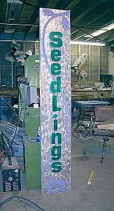 long sign in aluminum and glass paint