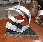 modern sculpture in marbel and aluminum for a contemporary stand