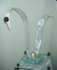 tabletop sculpture in brushed aluminum and glass base