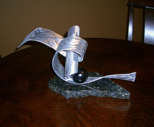 tabletop sculpture in aluminum and granite base, abstract sculpture designed in contemporary style
