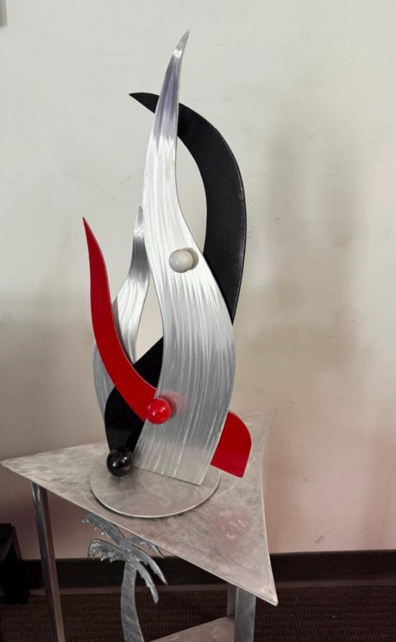 red and black tabletop sculpture in red black and aluminum
